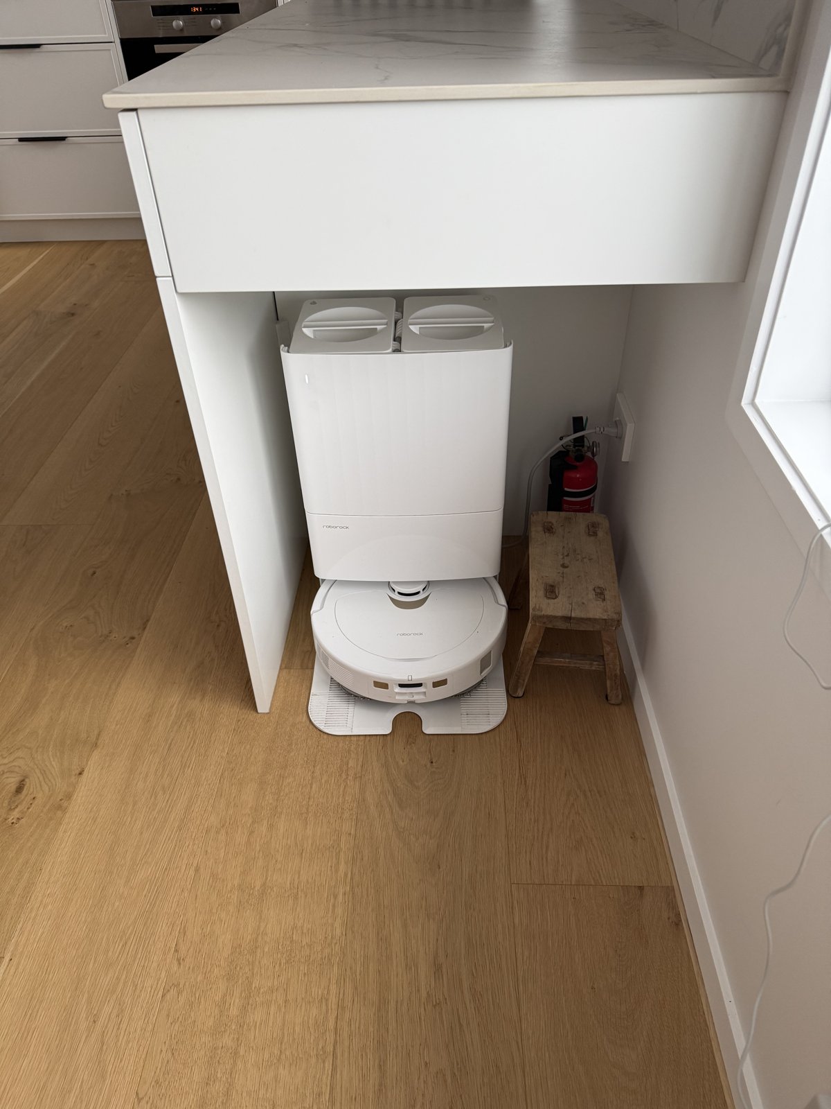 Fire extinguisher next to robot vacuum